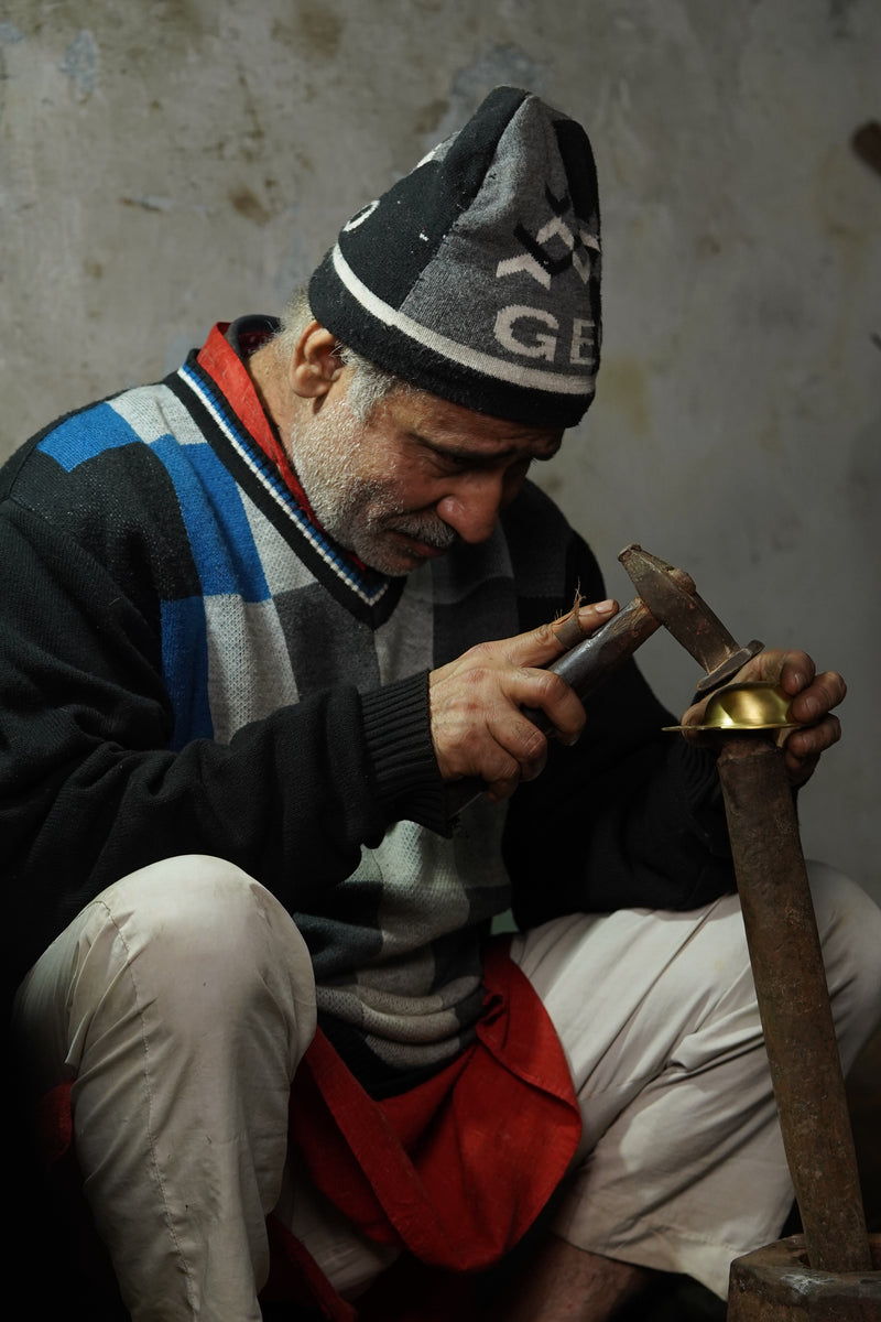 Brass artisan at work in a Moradabad workshop