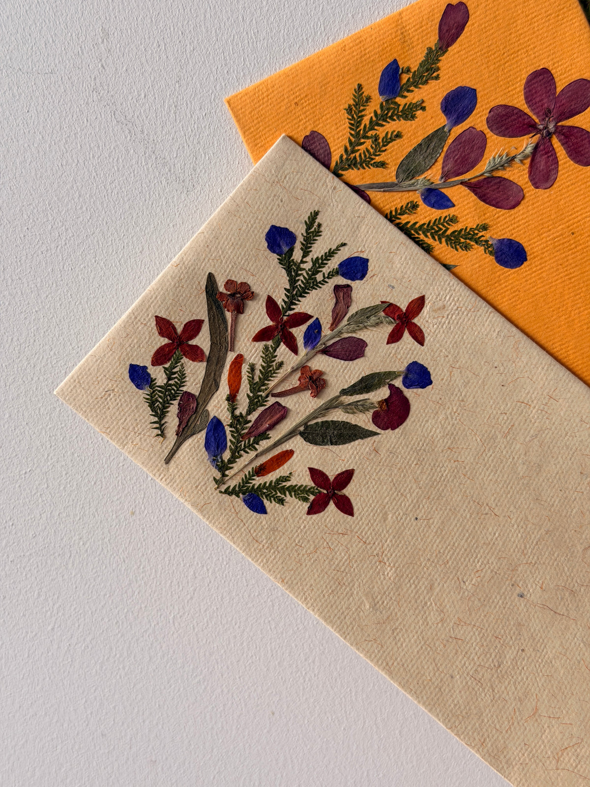 Close up of real Himalayan flowers pressed onto a shagun envelope