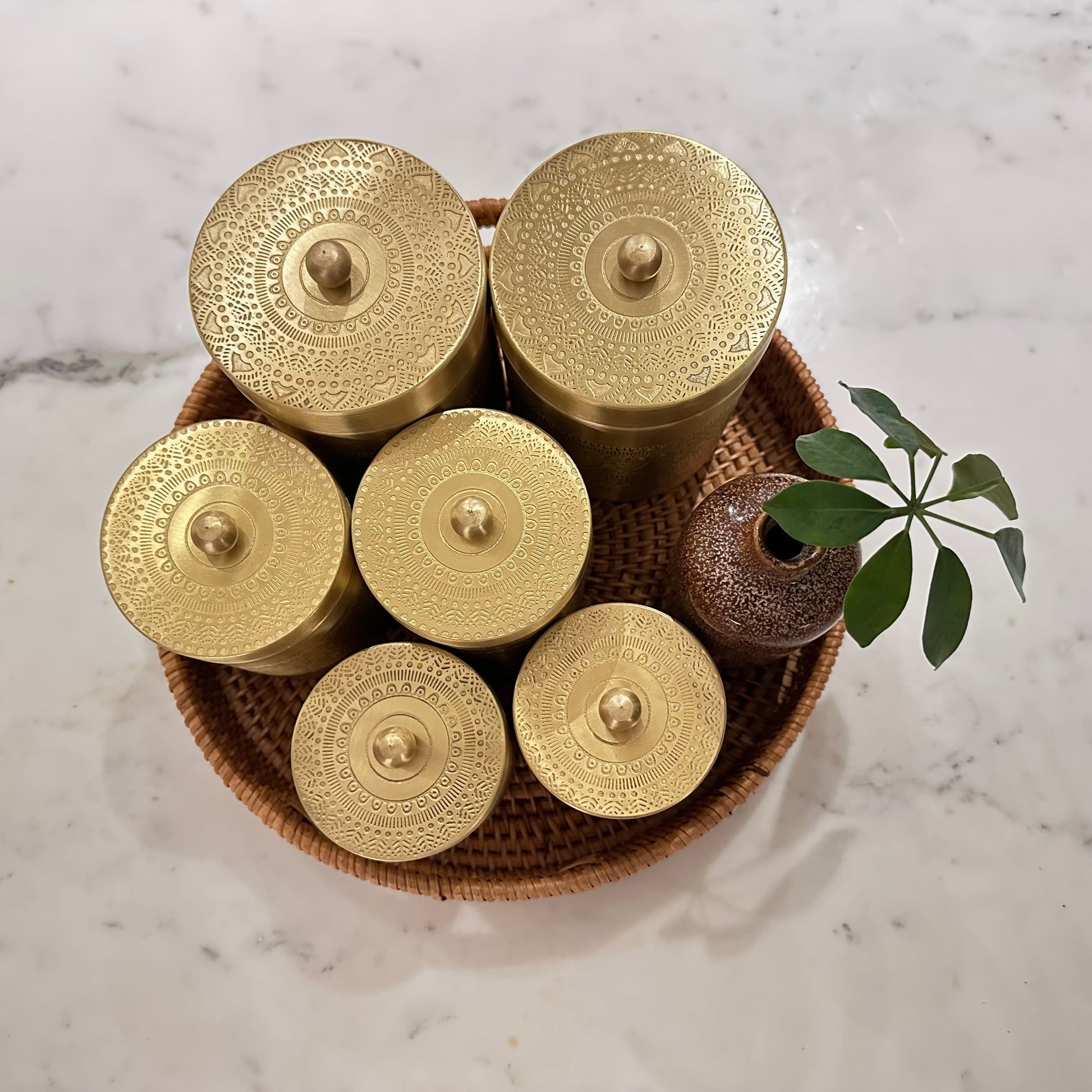 Brass tea, sugar and coffee canisters with engraved designs