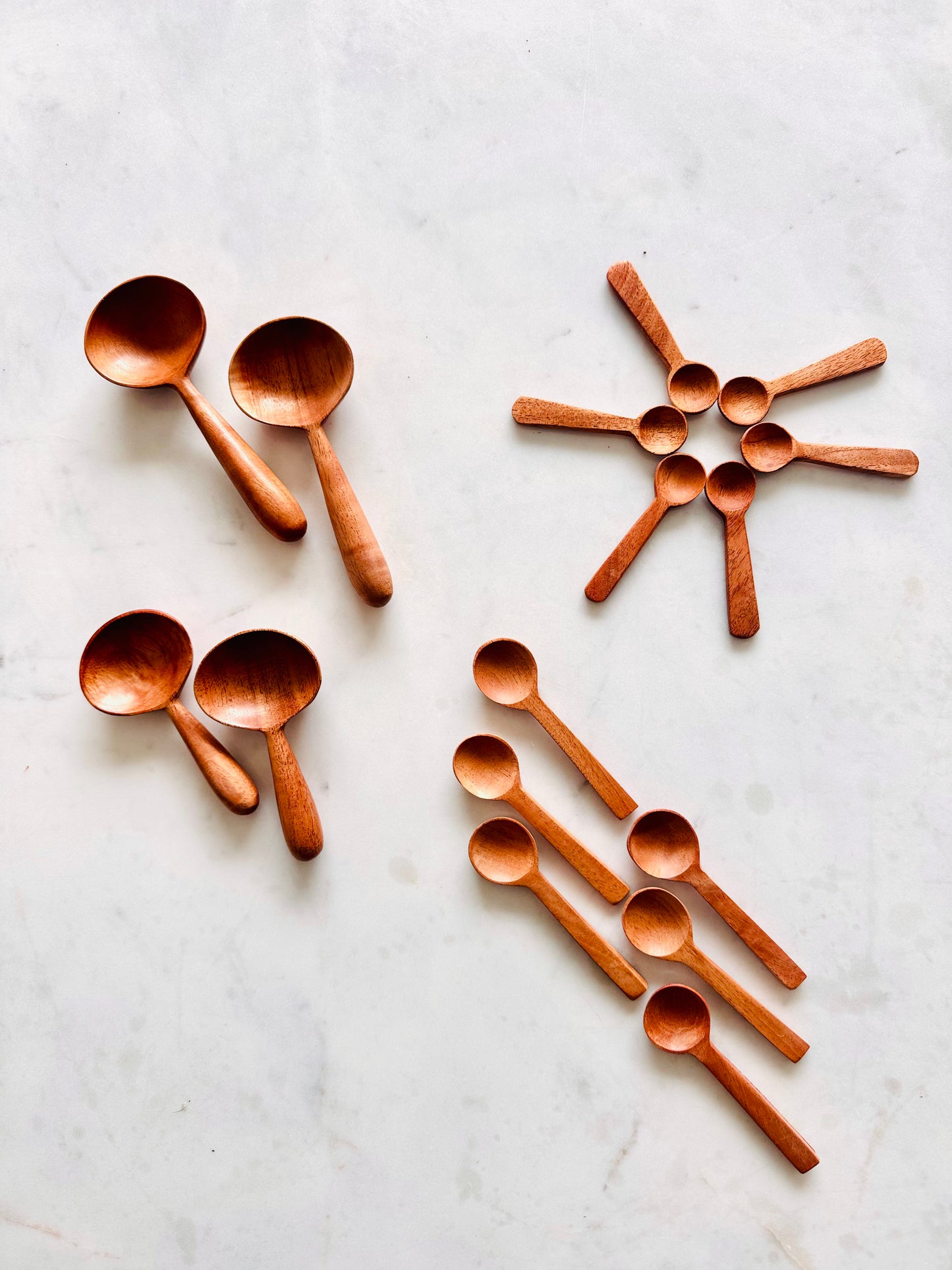 Wooden spoons arranged on a marble surface