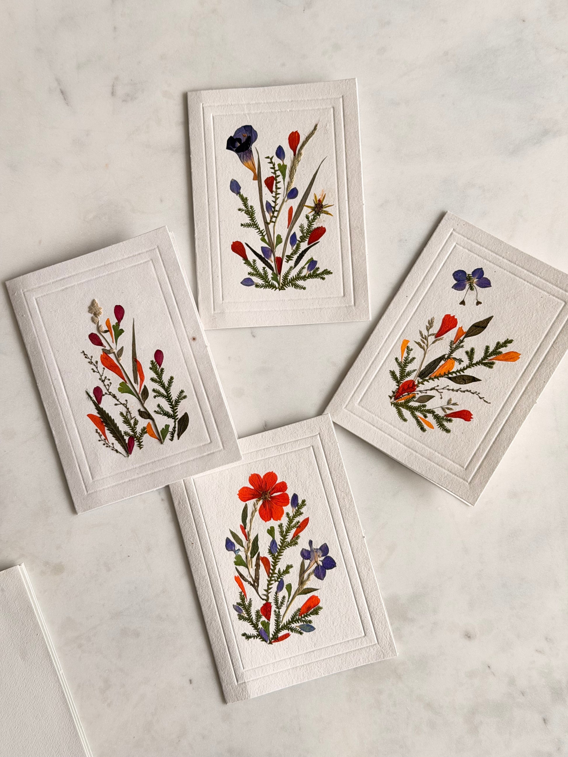 Set of floral cards on a marble surface