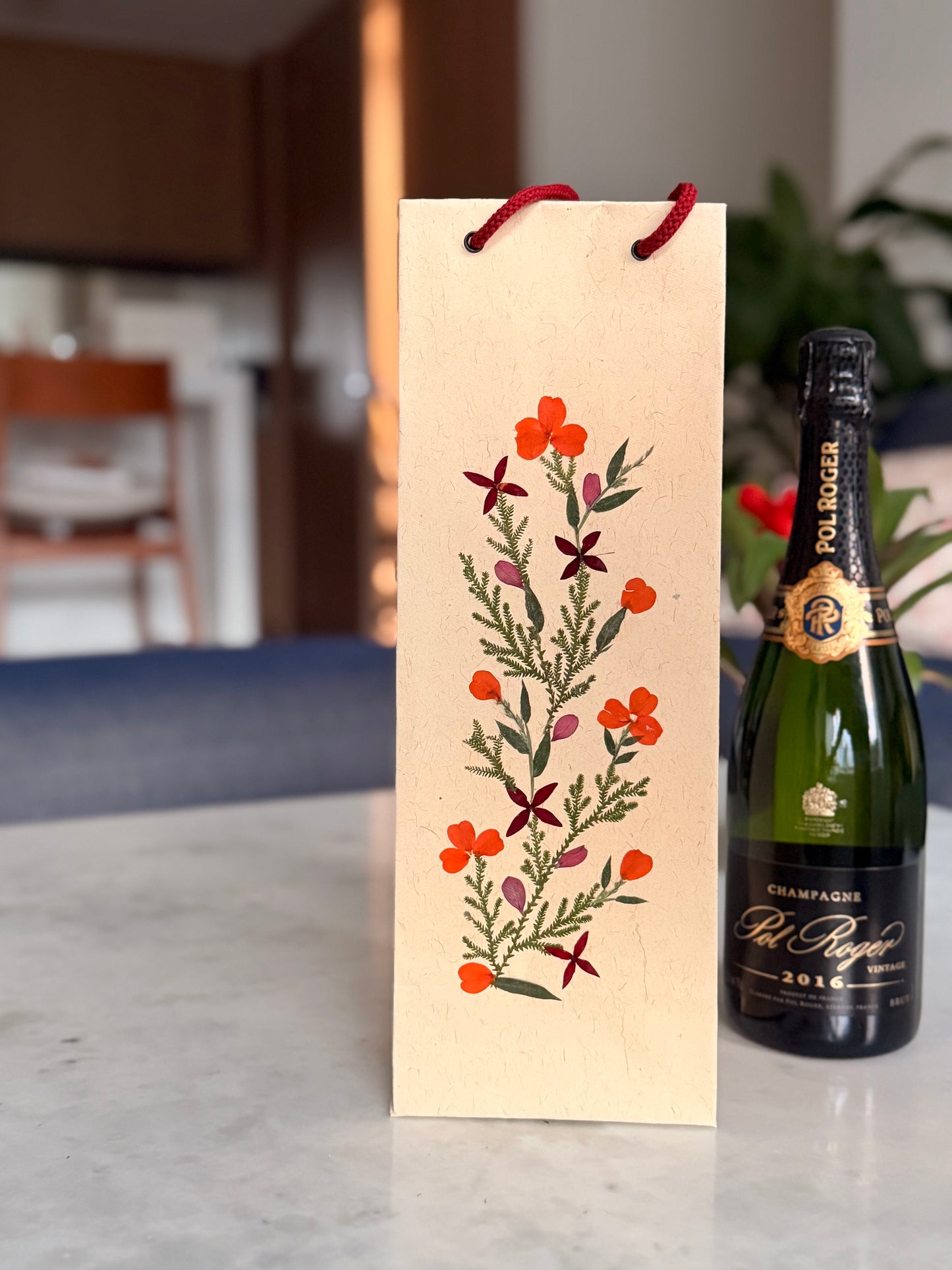 Bottle of champagne with decorative box on a marble surface