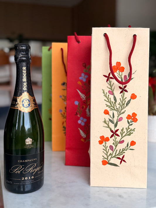 Wine bottle with decorative paper bag embellished with real pressed flowers 