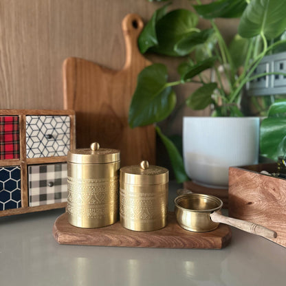 Brass tea, sugar and coffee canisters with a brass tea strainer