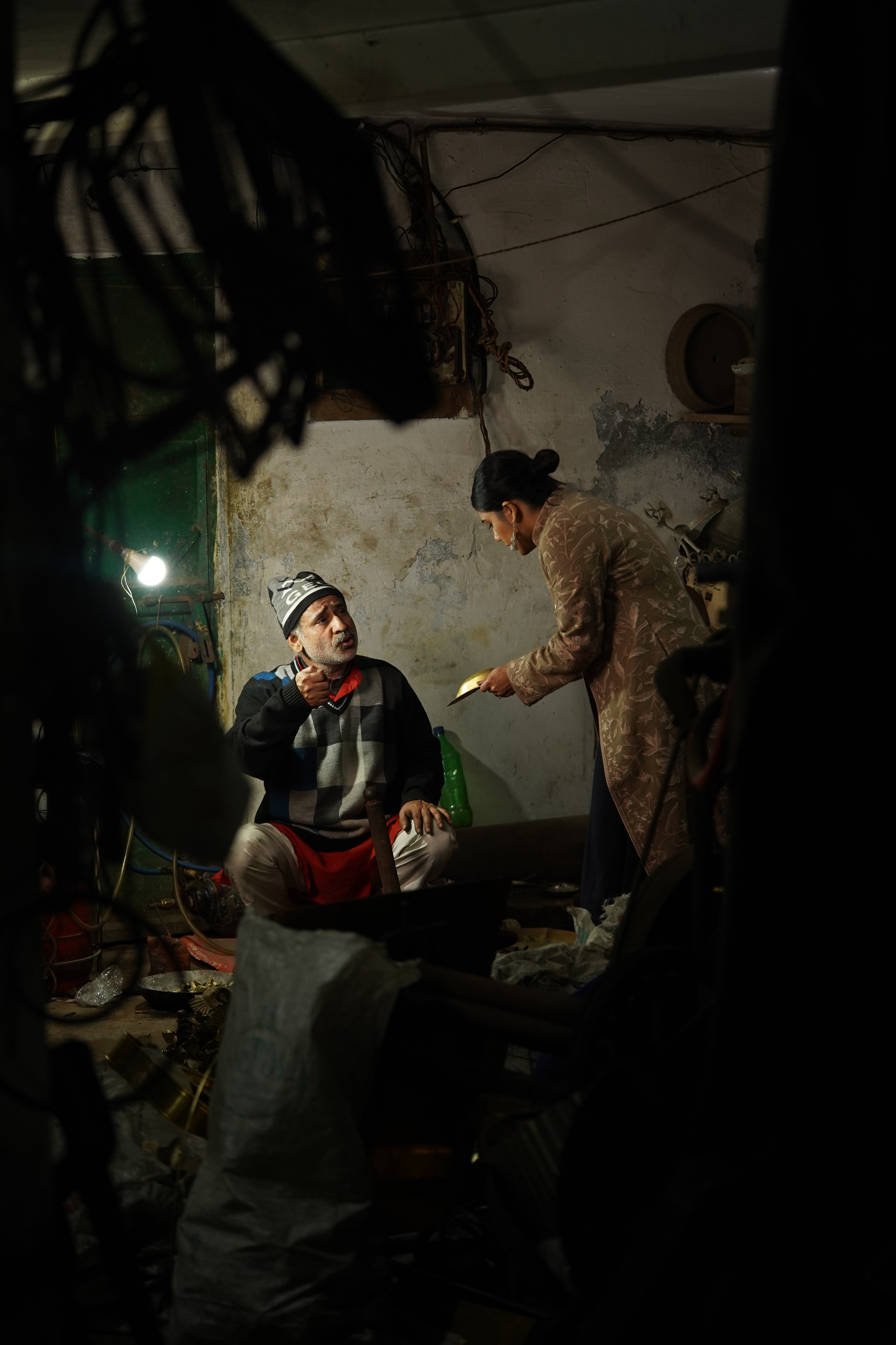 FOunder with Craftsman in brass workshop assessing a product