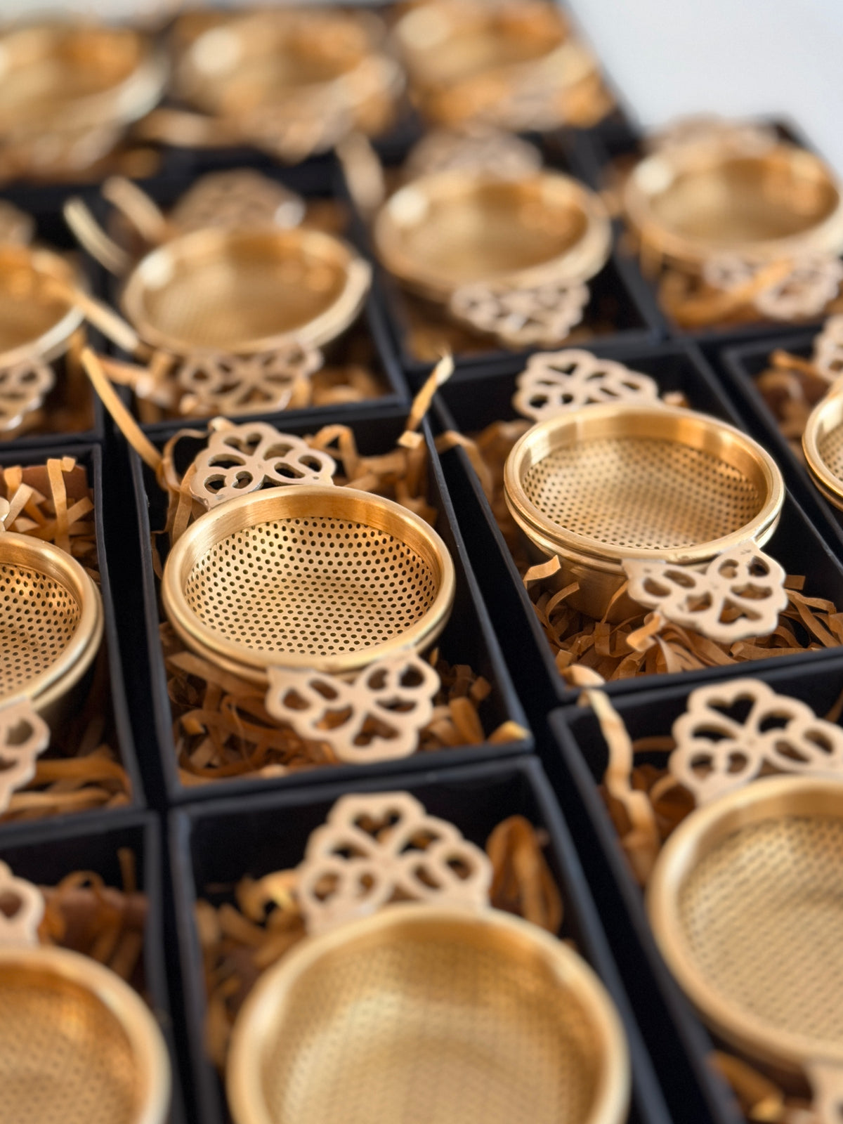 Brass tea strainers wrapped as wedding favours